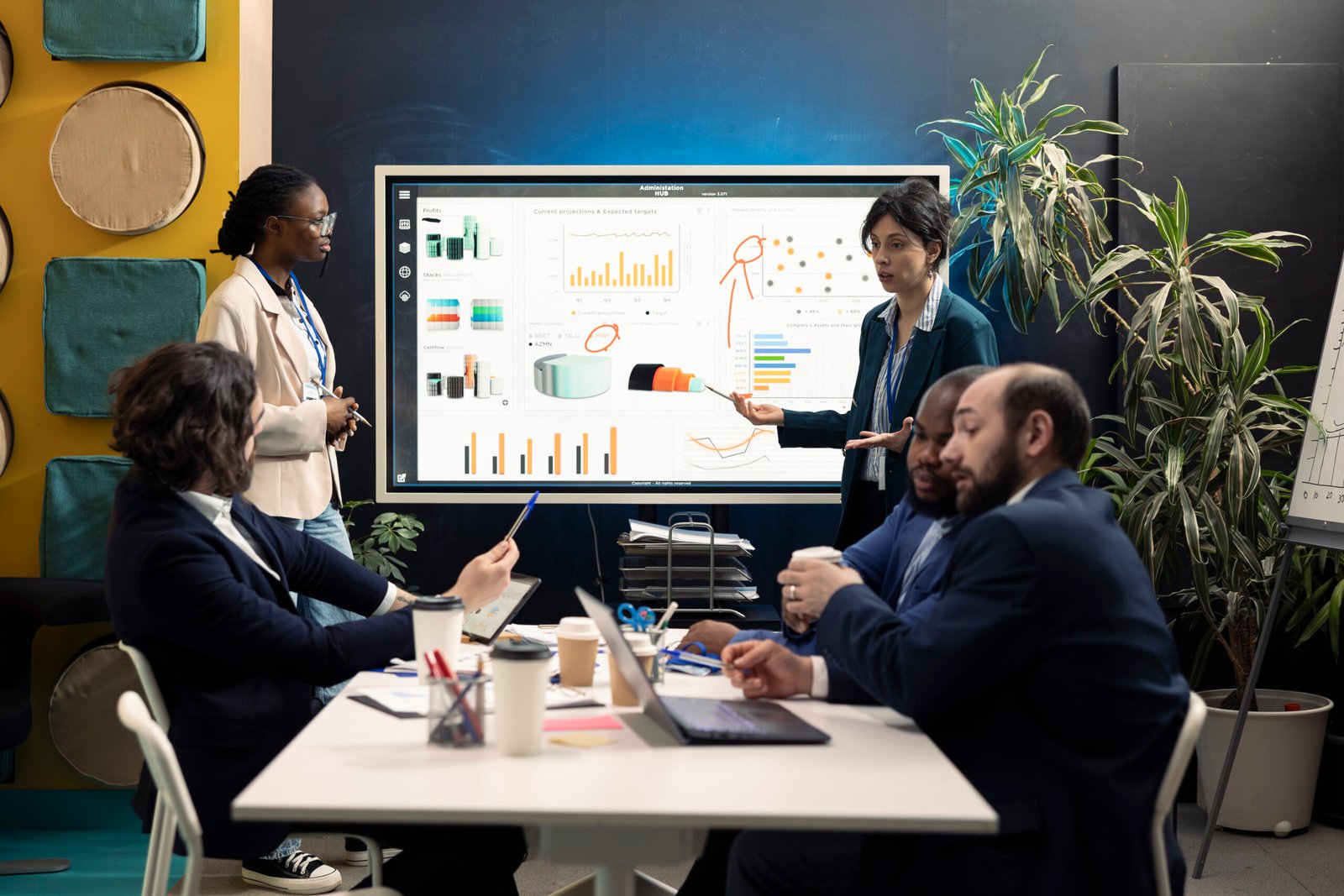 Team members from a financial organization showing insight on new projects during an executive meeting. Team of colleagues discussing the agenda for upcoming events in the industry.