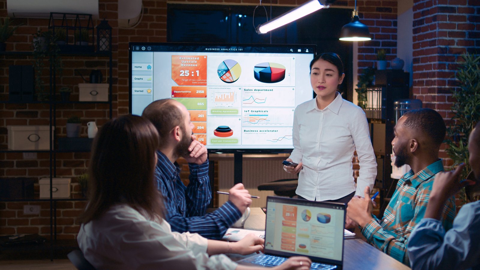 Team working on company revenue statistics presentation in business meeting, planning financial strategy. Coworkers discussing analytics report diagrams and charts in boardroom