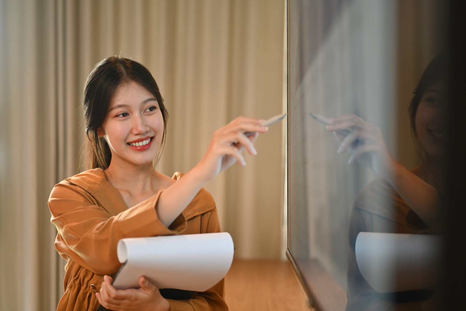 Professional businesswoman giving presentation, explaining report investment graph chart data in meeting room.